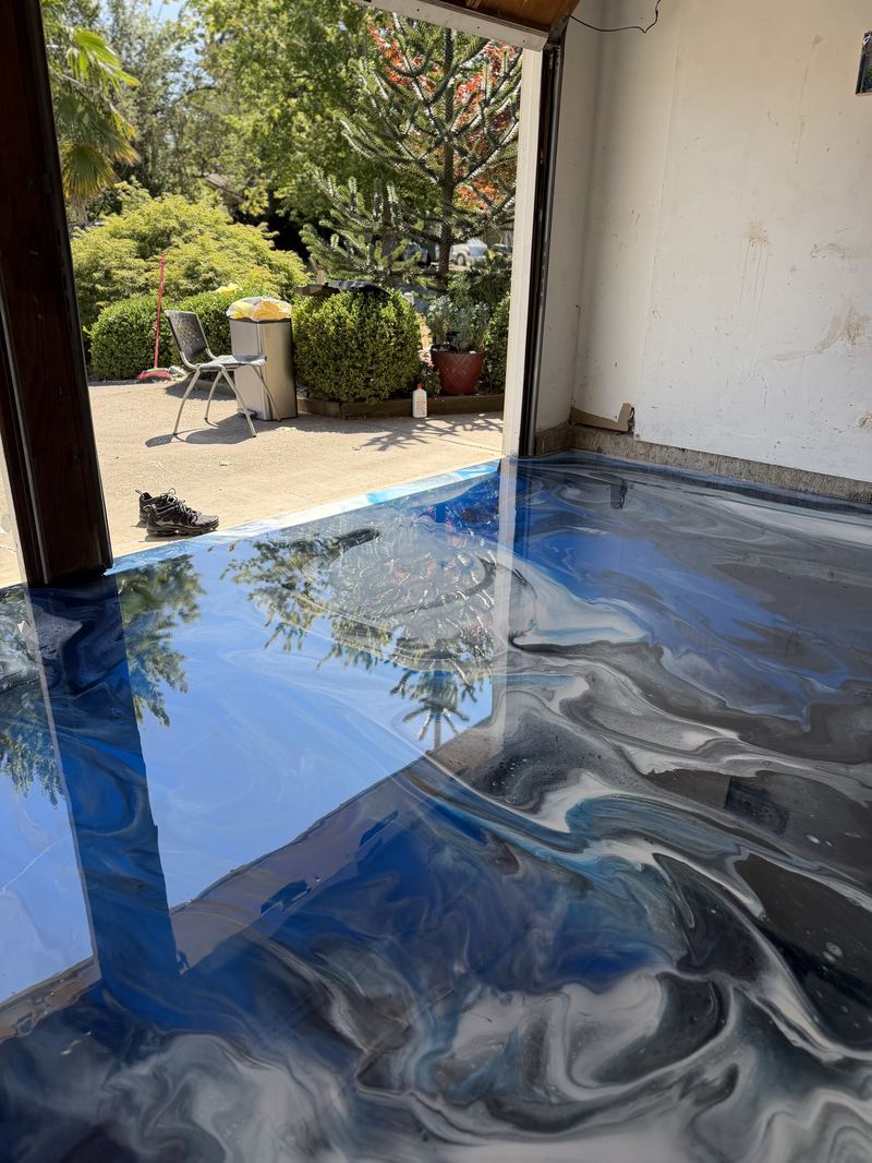 Blue and gray metallic epoxy floor with garden view