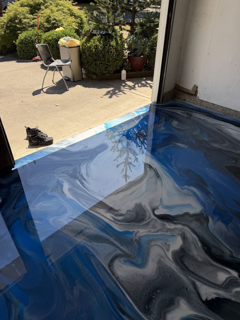 Blue metallic epoxy floor close-up with tree reflection