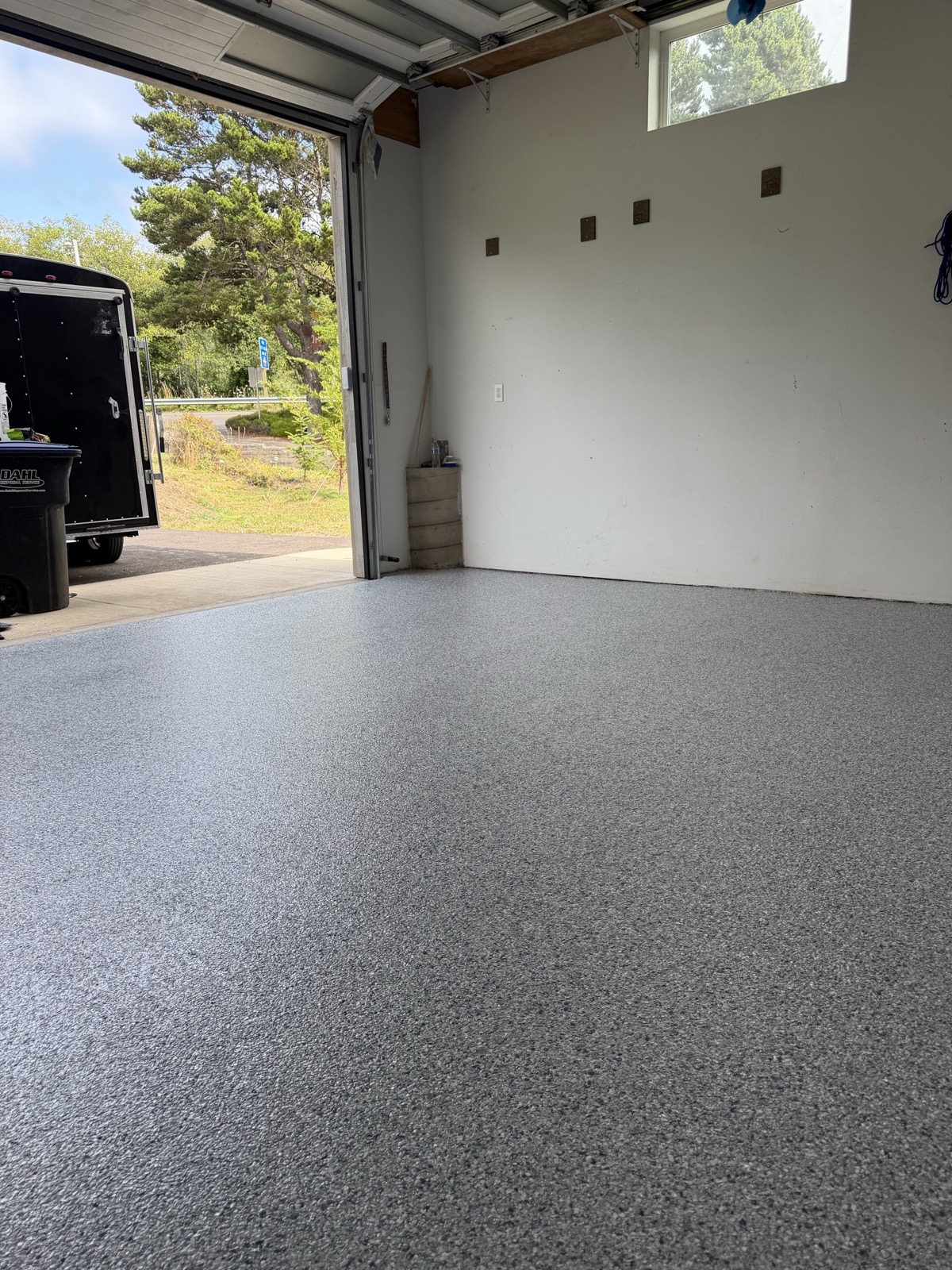 Gray flake epoxy garage floor with open door view