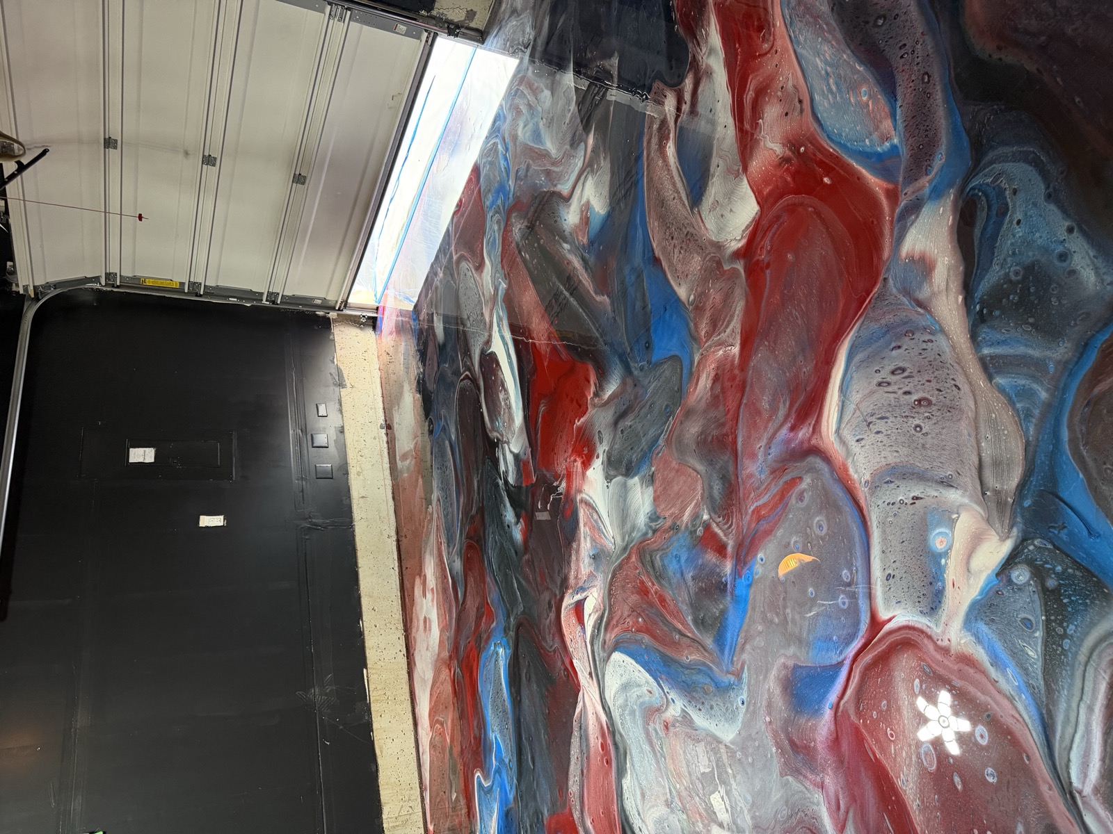 Red, white and blue metallic epoxy garage floor