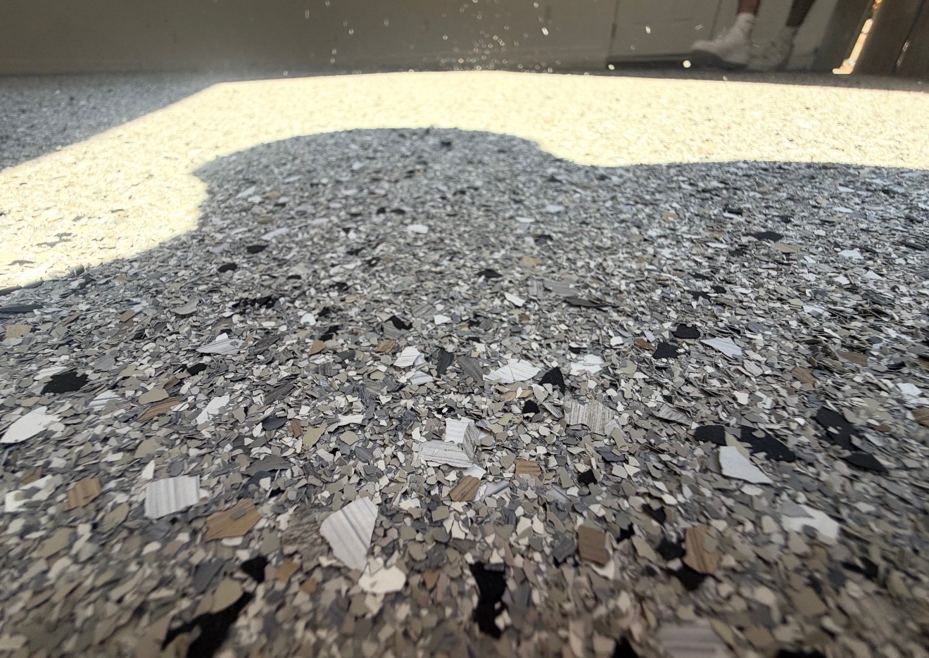 Close-up of gray, black and white flake epoxy floor texture