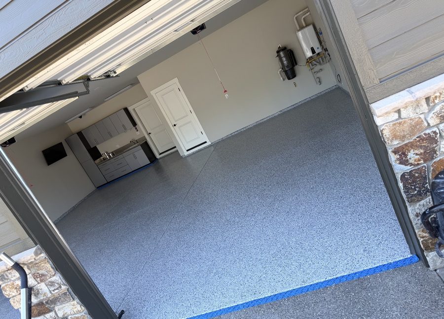 Gray flake epoxy garage floor with custom cabinets